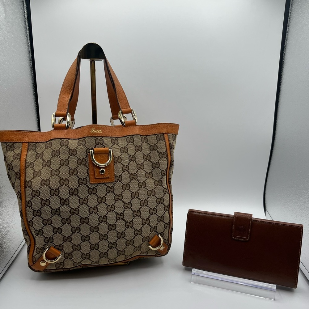 Authenticated and rare Gucci canvas tote. And authentic Gucci Leather wallet
